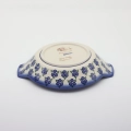 Round baking dish with handles made of Boleslawiec pottery.