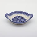 Hand decorated round baking dish with handles made from authentic Boleslawiec pottery.