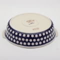 Round ceramic serving dish with handles – Bolesławiec pottery, hand-decorated with traditional patterns. Perfect for serving meats, salads, and appetizers. Stylish and durable Polish ceramic.