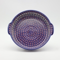Round ceramic serving platter with handles – hand-decorated Bolesławiec pottery with traditional patterns. Perfect for serving meats, salads, snacks, and family dishes. Durable and elegant Polish ceramic.
