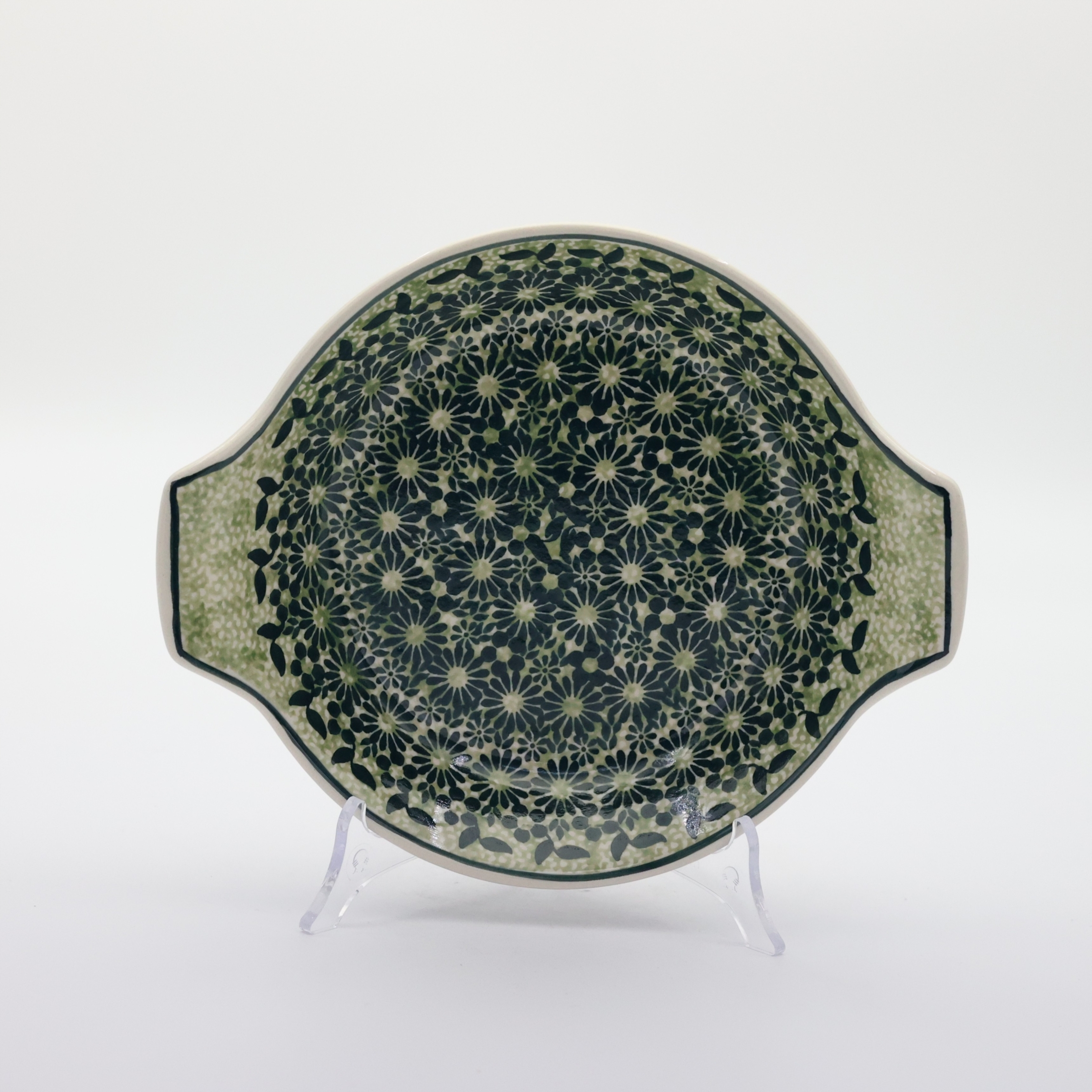 Round baking dish with handles made of Boleslawiec pottery.